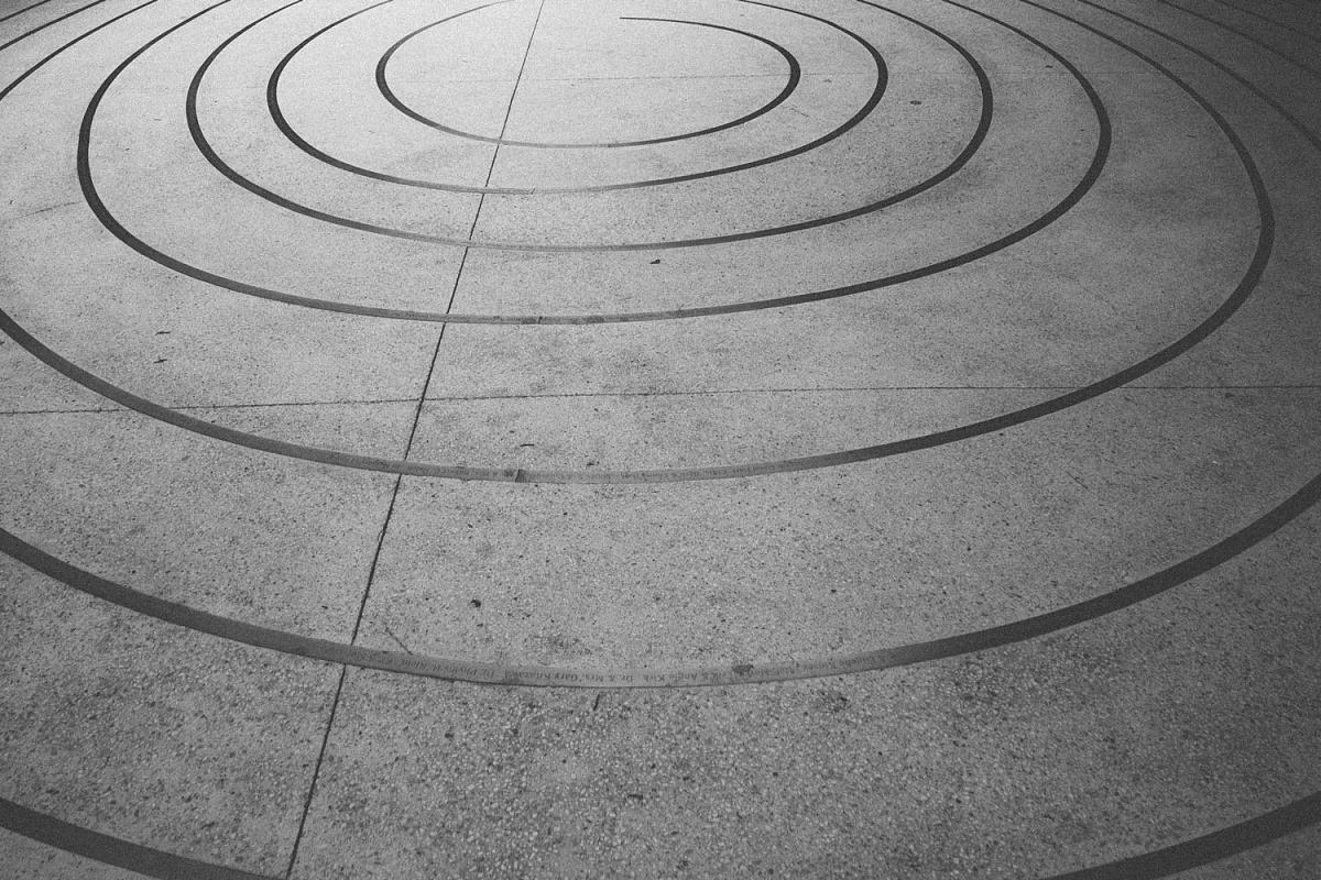 A spiral pattern cut into a grey concrete slab