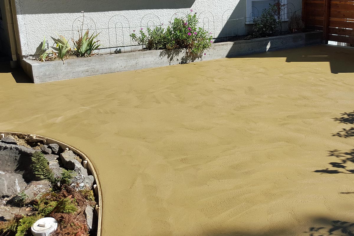 An example of a swirl finish using a hand trowel on tan-coloured exterior concrete